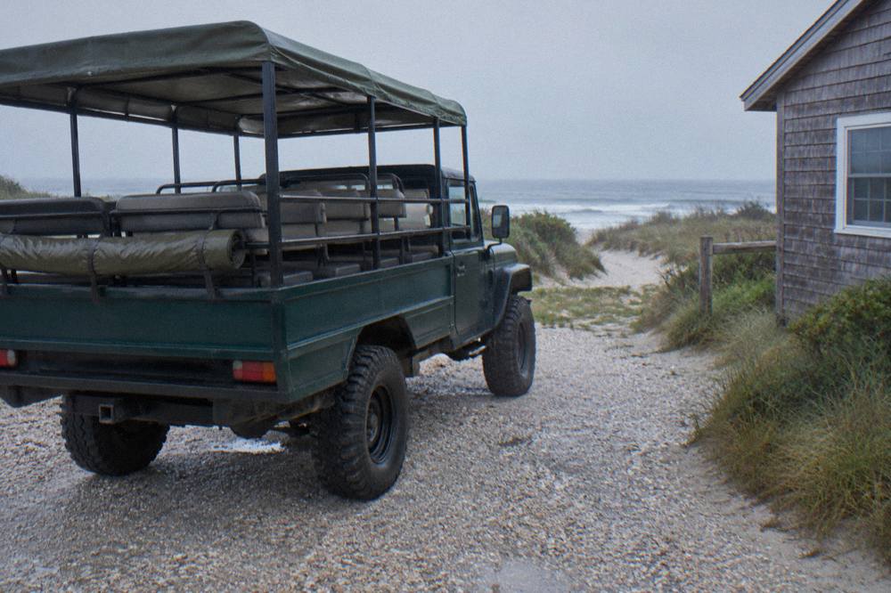 Open-air four wheel drive tour truck parked on the wide sand beach of the northern Outer Banks