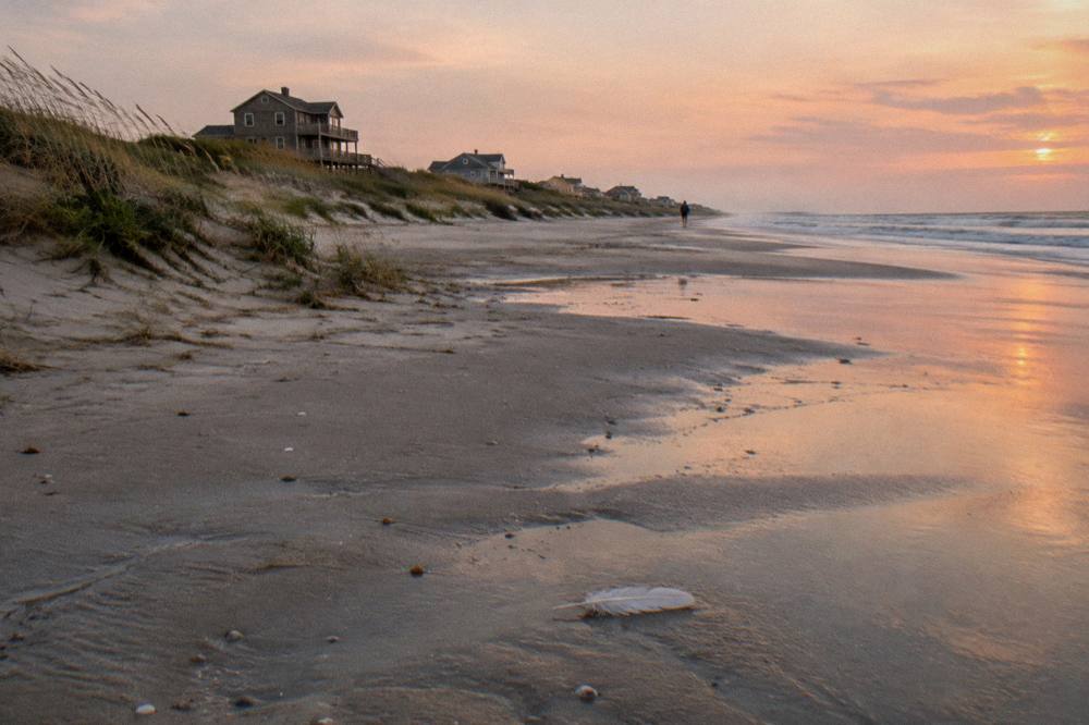 Empty northern beach in soft evening light with dunes and sea grass