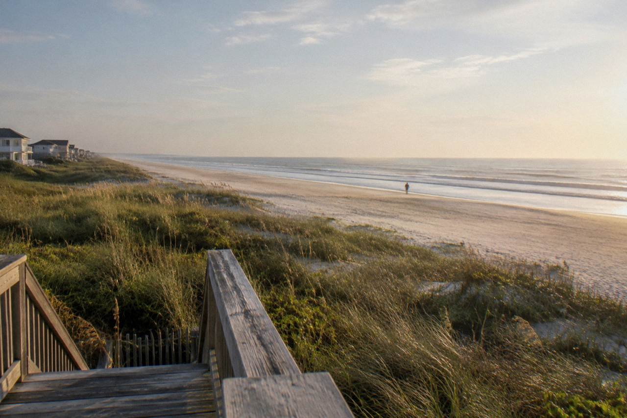 Wide beach at the northern Outer Banks with dune grass and open sand to the horizon