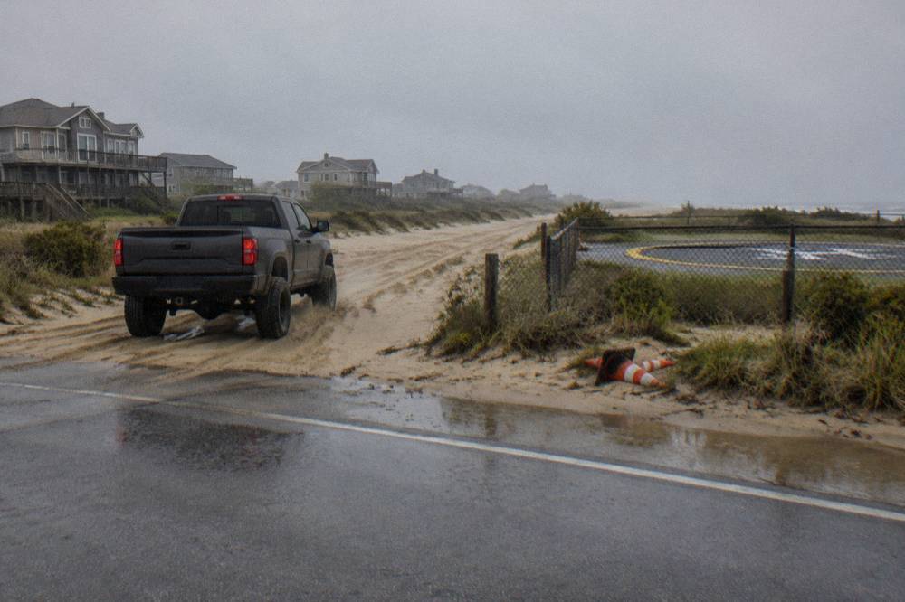 Beach access ramp at the end of the paved road where traffic drops onto the sand