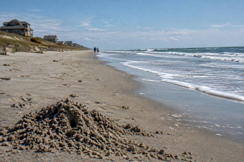 Gentle surf line on a wide northern Outer Banks beach under an open sky