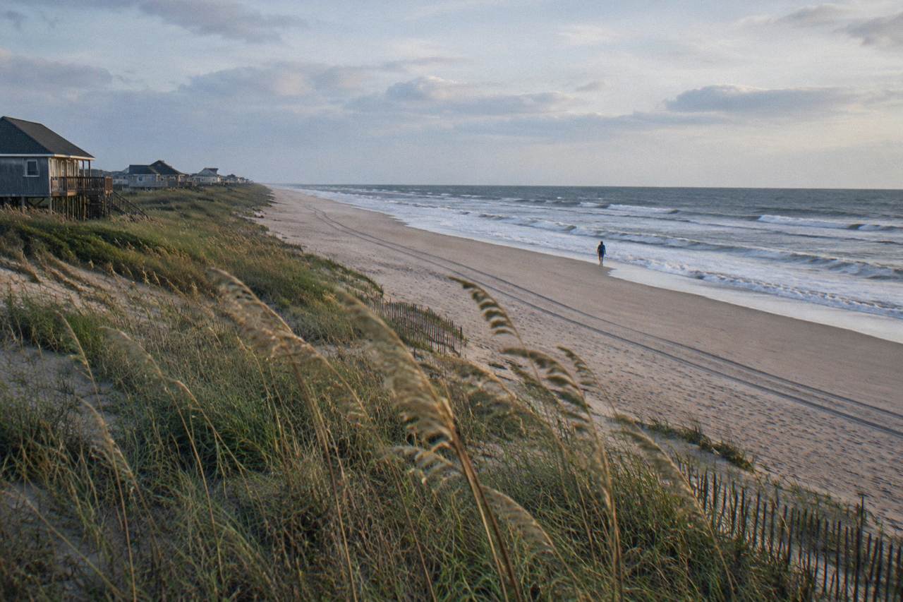 Open beach at the northern end of Corolla with sand dunes and sea oats along the shoreline