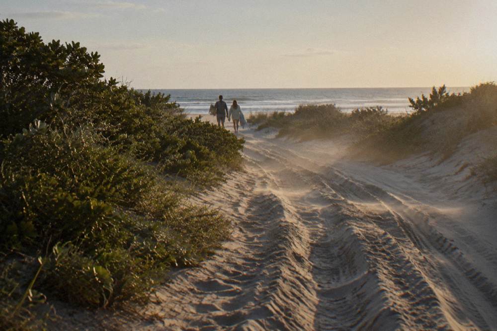 Open sandy track through low brush toward the beach in the four wheel drive area