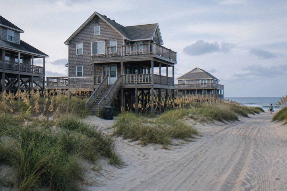Vacation houses set among sand dunes and sea oats along a quiet northern beach
