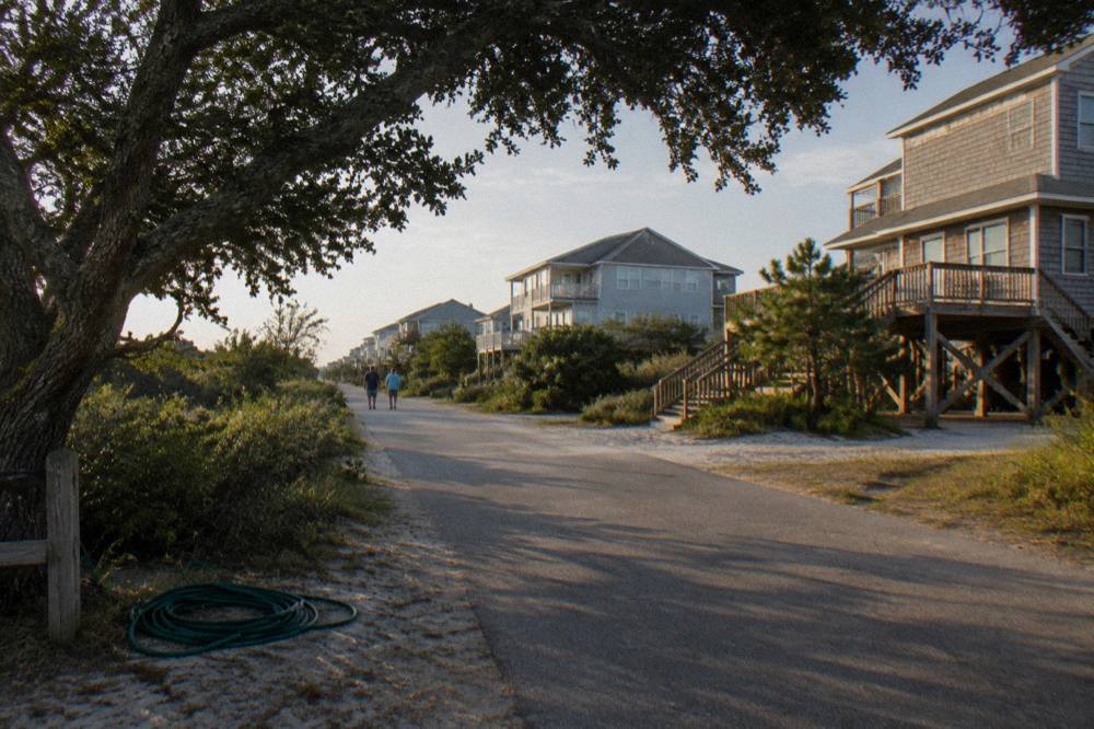 Oceanfront rental homes along a quiet street in Corolla village near the dune line