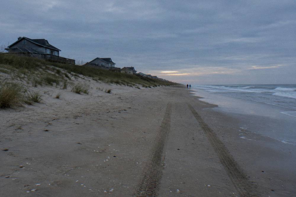 Empty morning beach in Corolla with soft light over wet sand and low dunes