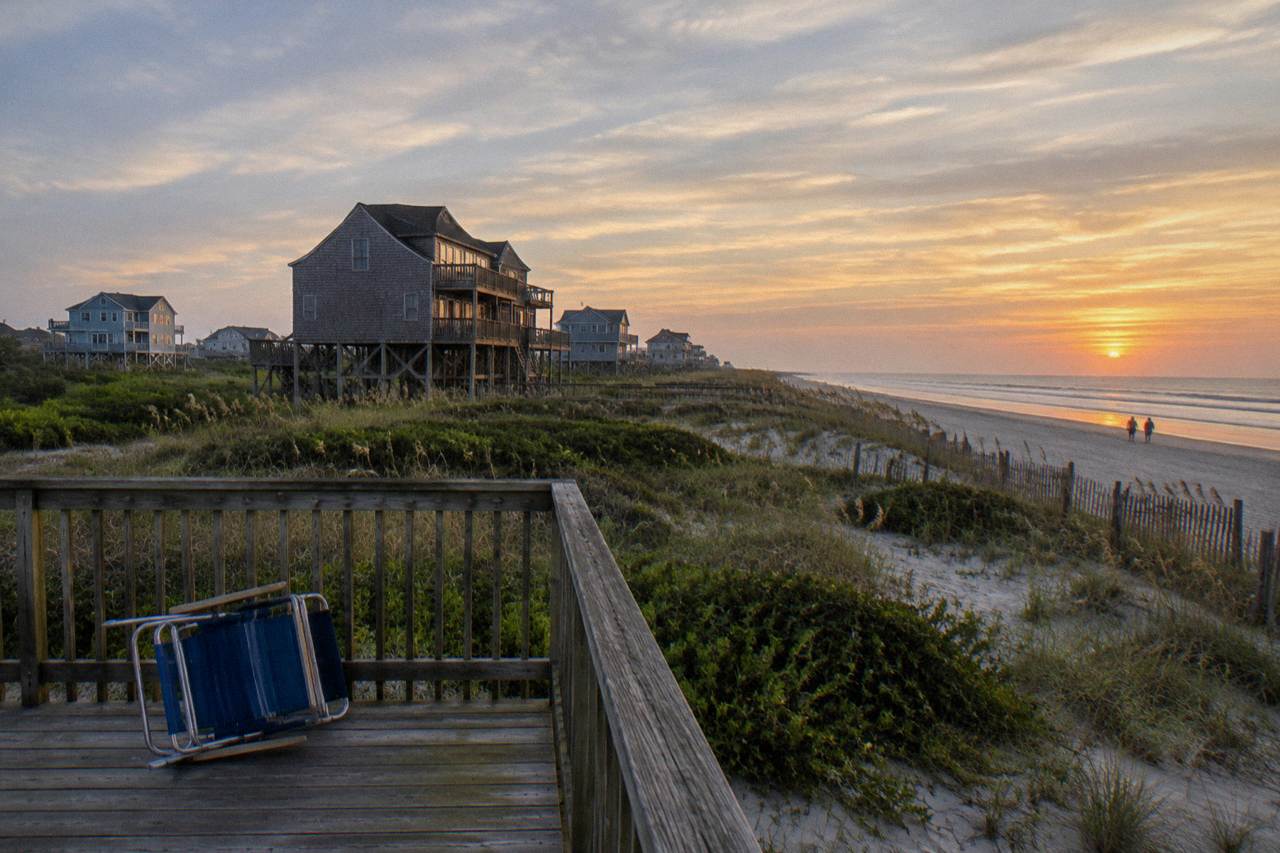 Beach houses behind the dunes at the northern end of Corolla, North Carolina under a wide sky